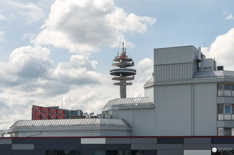 Telecommunications Tower Rising Behind Industrial Building Complex