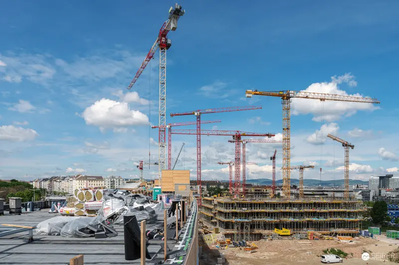 Large-Scale Urban Construction Site with Multiple Tower Cranes and Concrete Structures