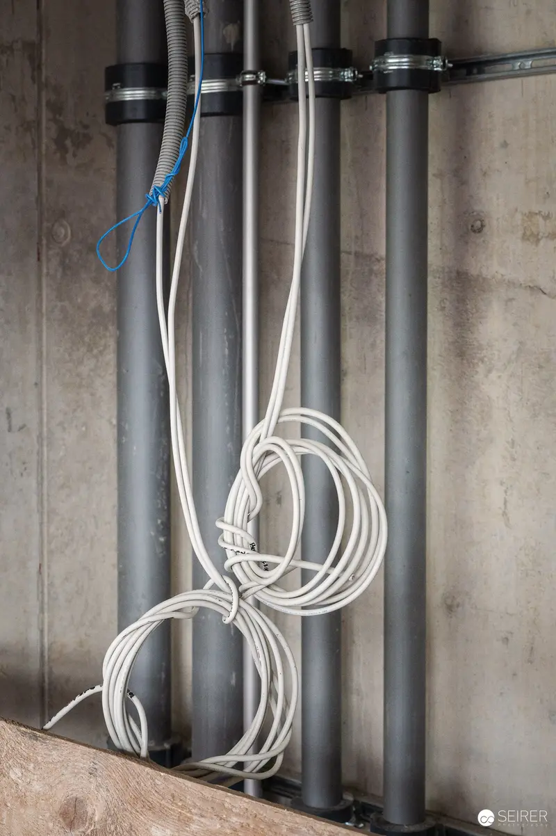 Coiled Cables and Vertical Pipes in Construction Infrastructure Installation