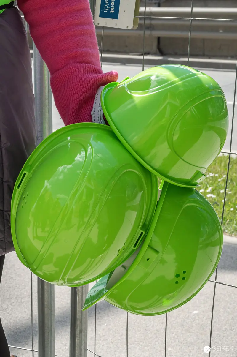 Bright Green Safety Helmets Distributed at Construction Site Visit