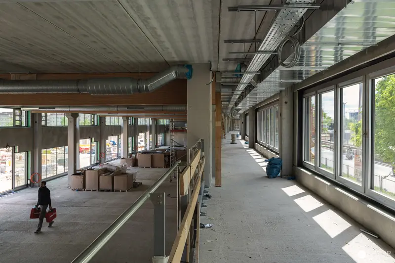 Construction Site Interior During Final Phases with Worker and Industrial Elements