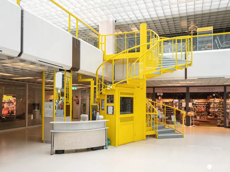Bright Yellow Spiral Staircase in Modern Indoor Commercial Space