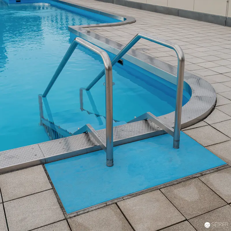 Swimming Pool Accessibility Ramp with Blue Safety Platform and Handrails