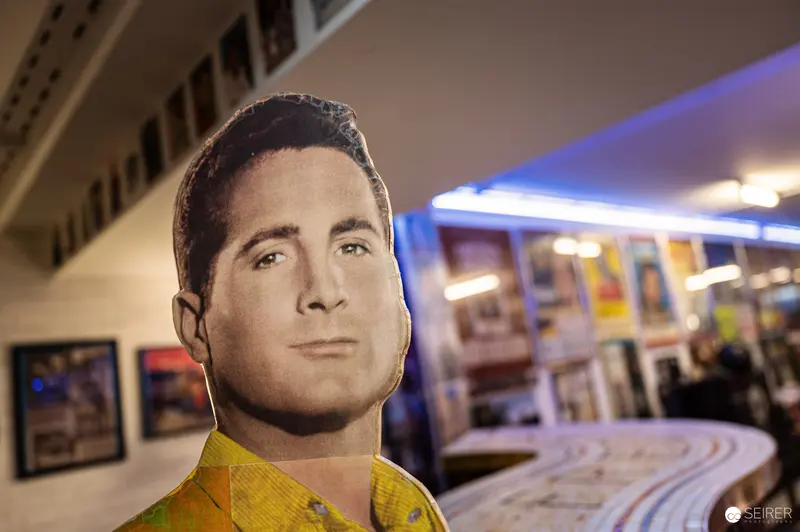Cardboard Cutout of Actor in Retail Space with Blue Lighting