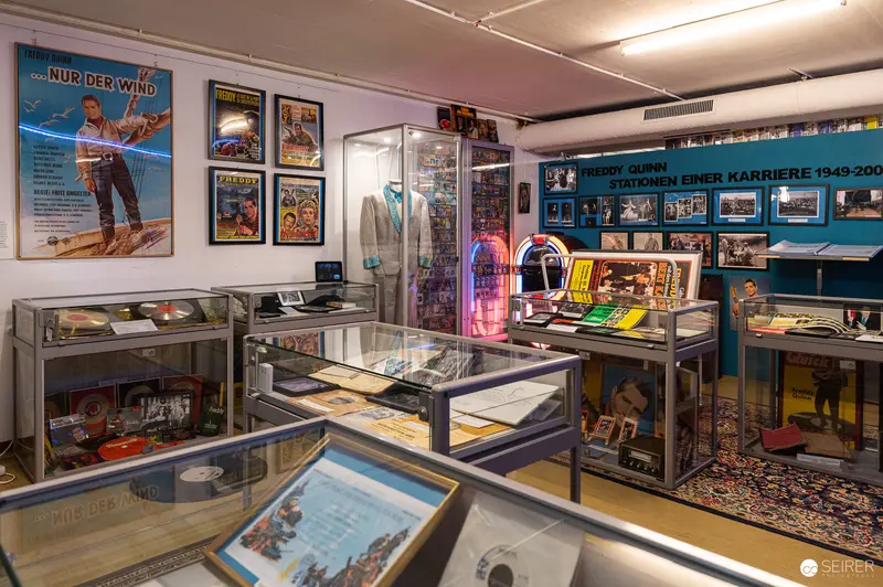 Vintage Museum Display Showcasing Nostalgic Posters, Jukebox, and Retro Memorabilia