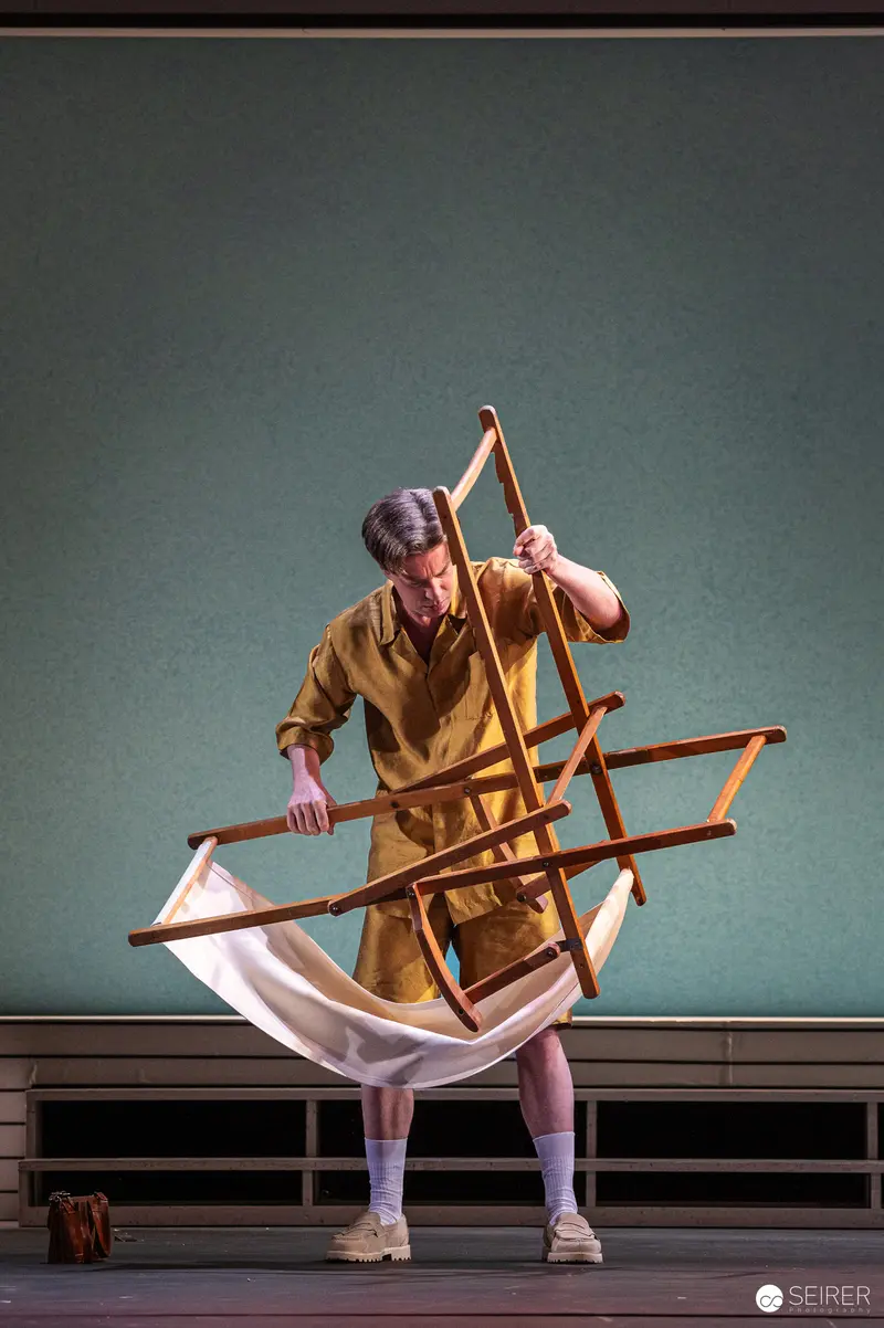 Actor Manipulating Wooden Frame in "Trilogie der Sommerfrische" at Theater in der Josefstadt