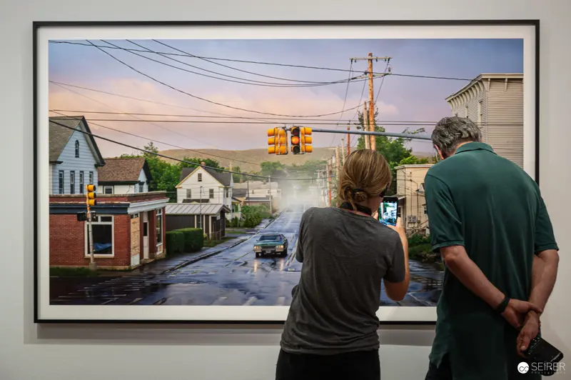 Visitors photographing a Gregory Crewdson street tableau at the Albertina, Vienna