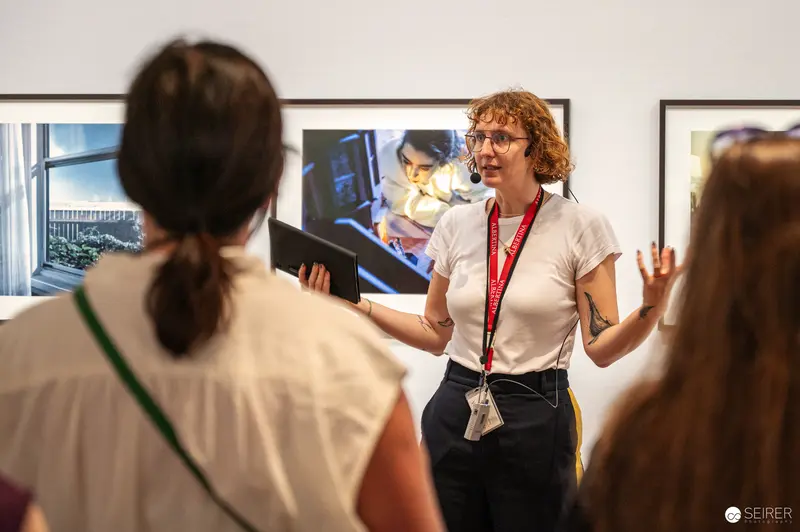 Albertina museum educator guides visitors through Gregory Crewdson exhibition, Vienna, June 2024