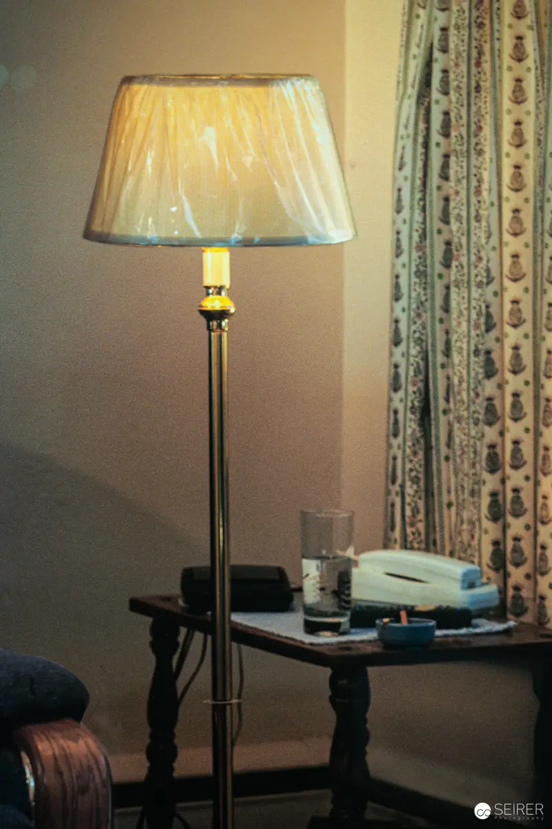 Lit brass floor lamp and side table, Gregory Crewdson exhibition, Albertina Vienna 2024