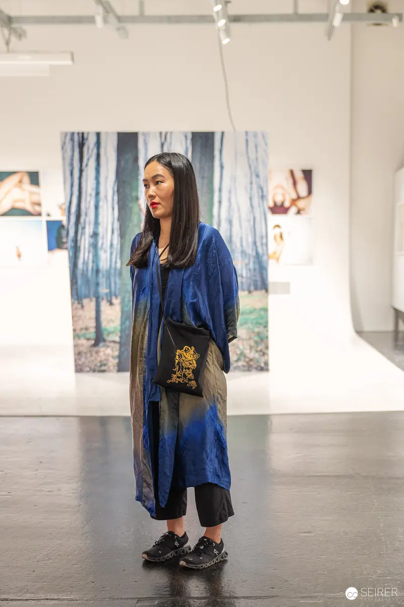 Woman in Blue Coat at WestLicht Gallery "Inside Views" Event in Vienna