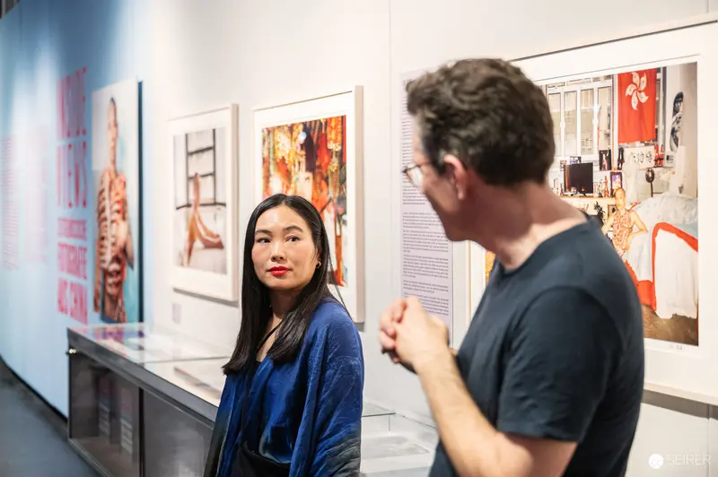Art Gallery Visitors Examining Contemporary Exhibition Artworks