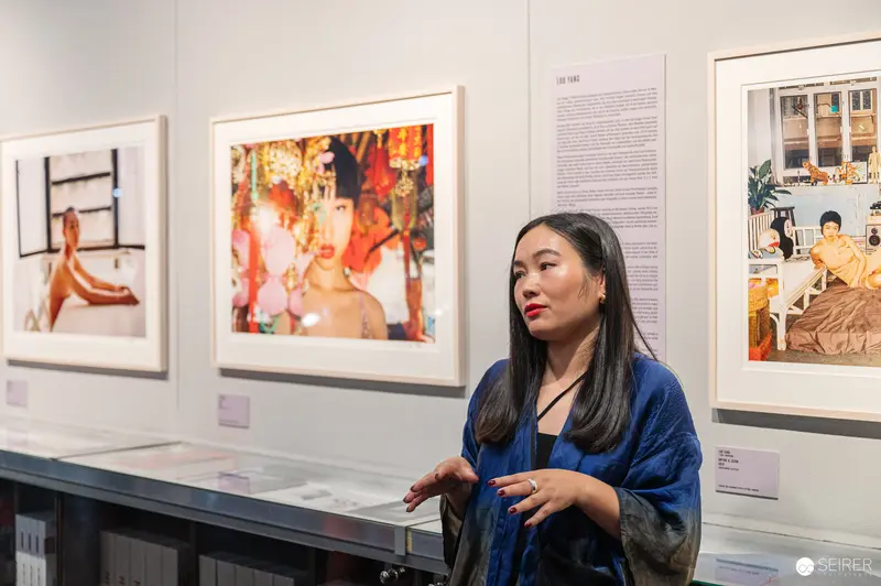 Art Gallery Curator Examining Photographic Exhibition in Contemporary Space