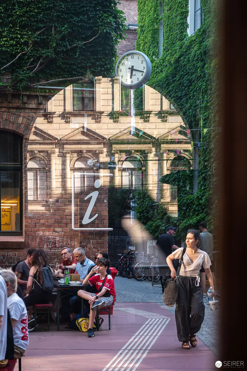 Urban Courtyard Scene at WUK Cultural Center with Pedestrian and Street Clock