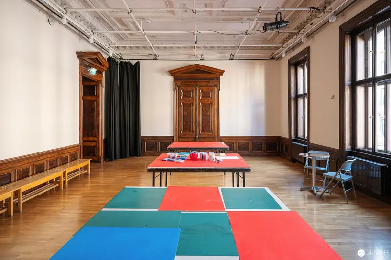 Colorful Modular Classroom Space with Geometric Floor Design and Wooden Furnishings
