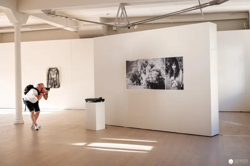 Photographer Documenting Art Exhibition at WUK Cultural Center in Vienna