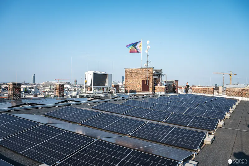 Rooftop Solar Installation with City Skyline at Urban Sustainable Energy Site