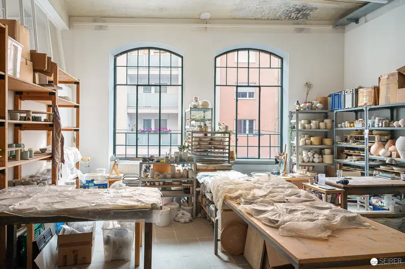 Ceramic Workshop Interior with Handmade Pottery and Clay Workstations