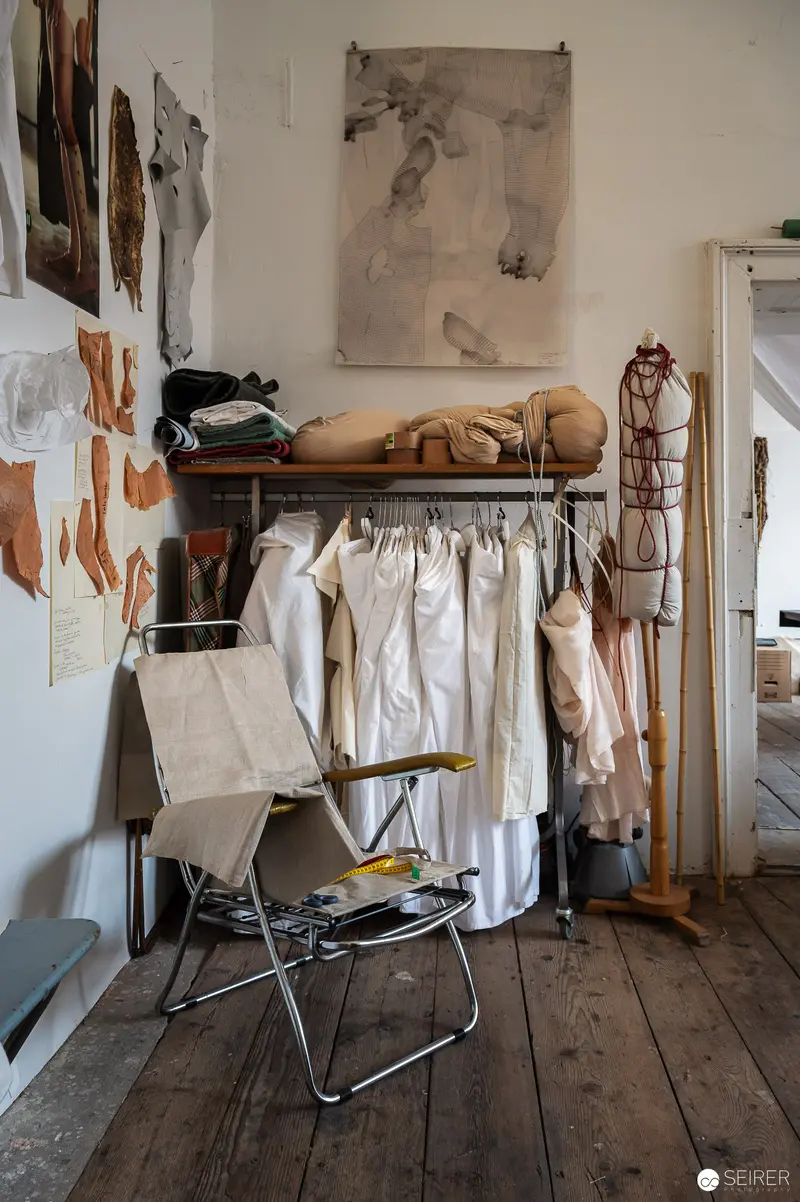 Artist's Studio Interior with Hanging Garments and Textile Artwork