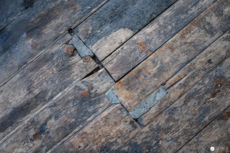 Weathered Wooden Planks with Rusty Metal Connectors in Diagonal Composition
