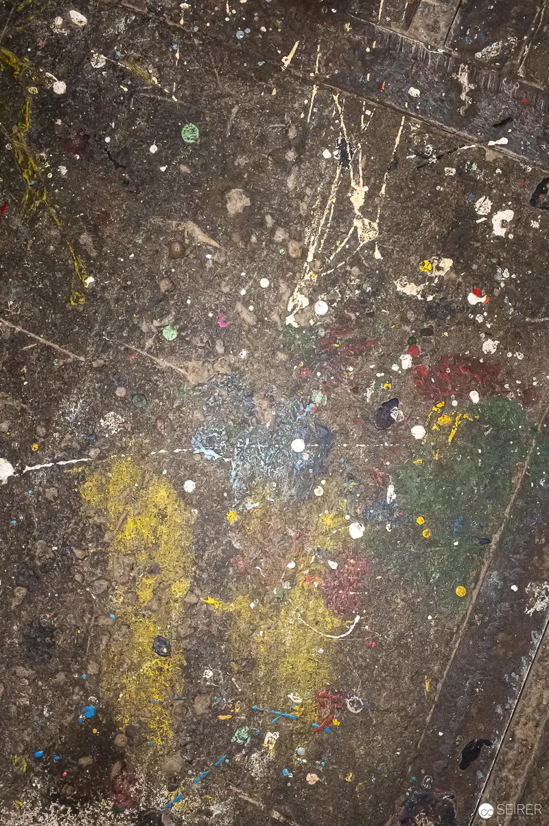 Abstract Paint-Splattered Studio Floor with Colorful Scattered Fragments