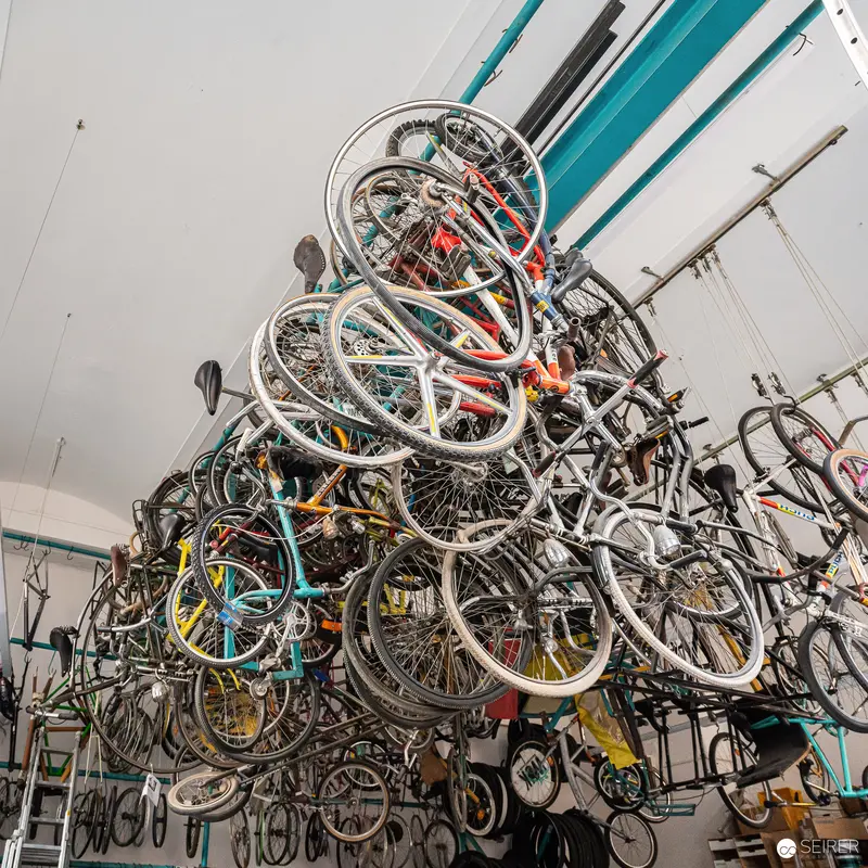 Massive Bicycle Wheel Sculpture Assembled in Industrial Workshop Interior
