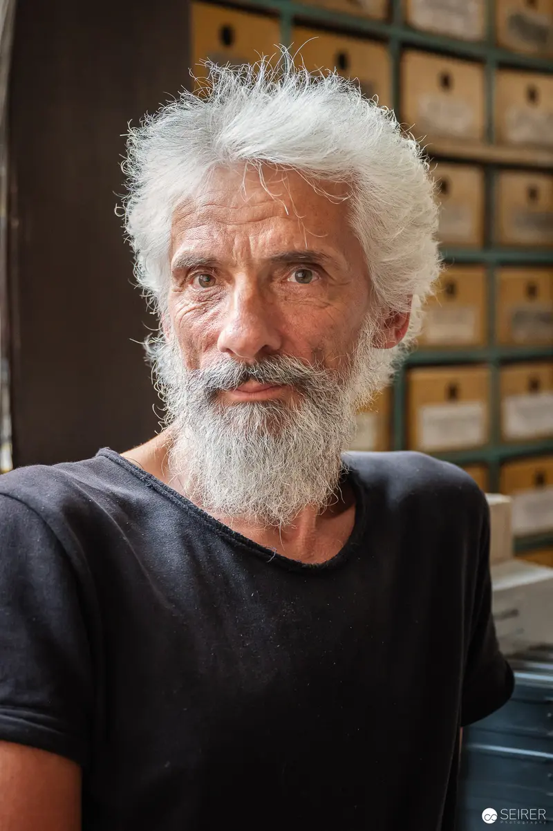 WUK Workshop Portrait of Senior Craftsman with White Hair and Beard