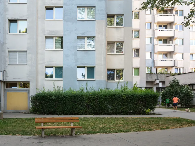 Urban Residential Complex with Bench and Green Landscaping in Vienna