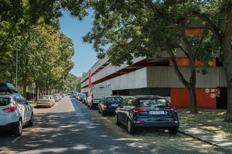 Urban Parking Scene with Cars Lined Along Shaded Street in Residential Area