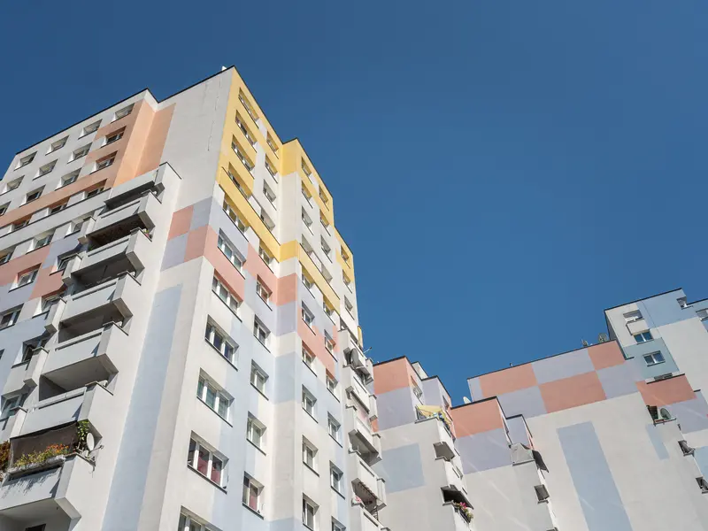 Colorful Multi-Story Residential Apartment Complex with Pastel Facade Against Blue Sky