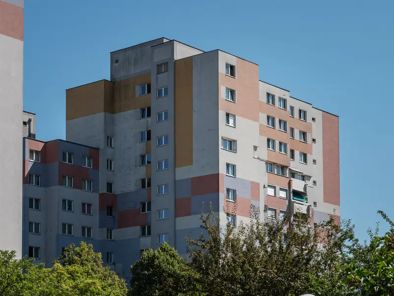 Pastel-Colored Residential Block Against Clear Blue Sky in Urban Setting