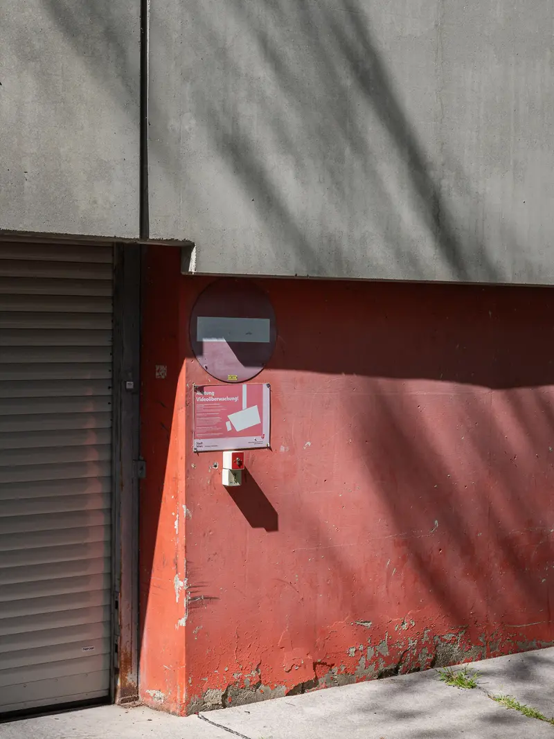 Rusty Red Wall with Weathered Exterior and Architectural Shadow Patterns