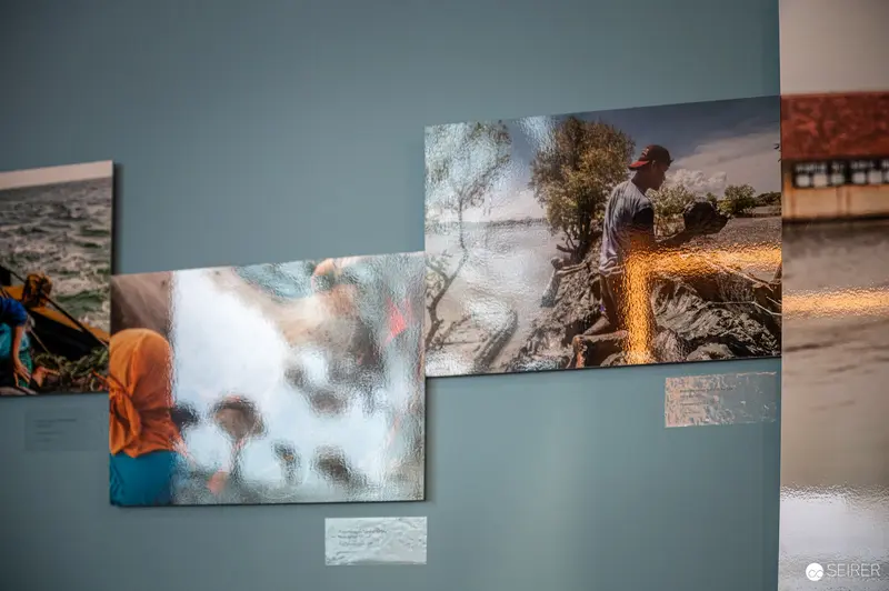 Photographic Exhibition Displaying Multiple Documentary Images on Wall