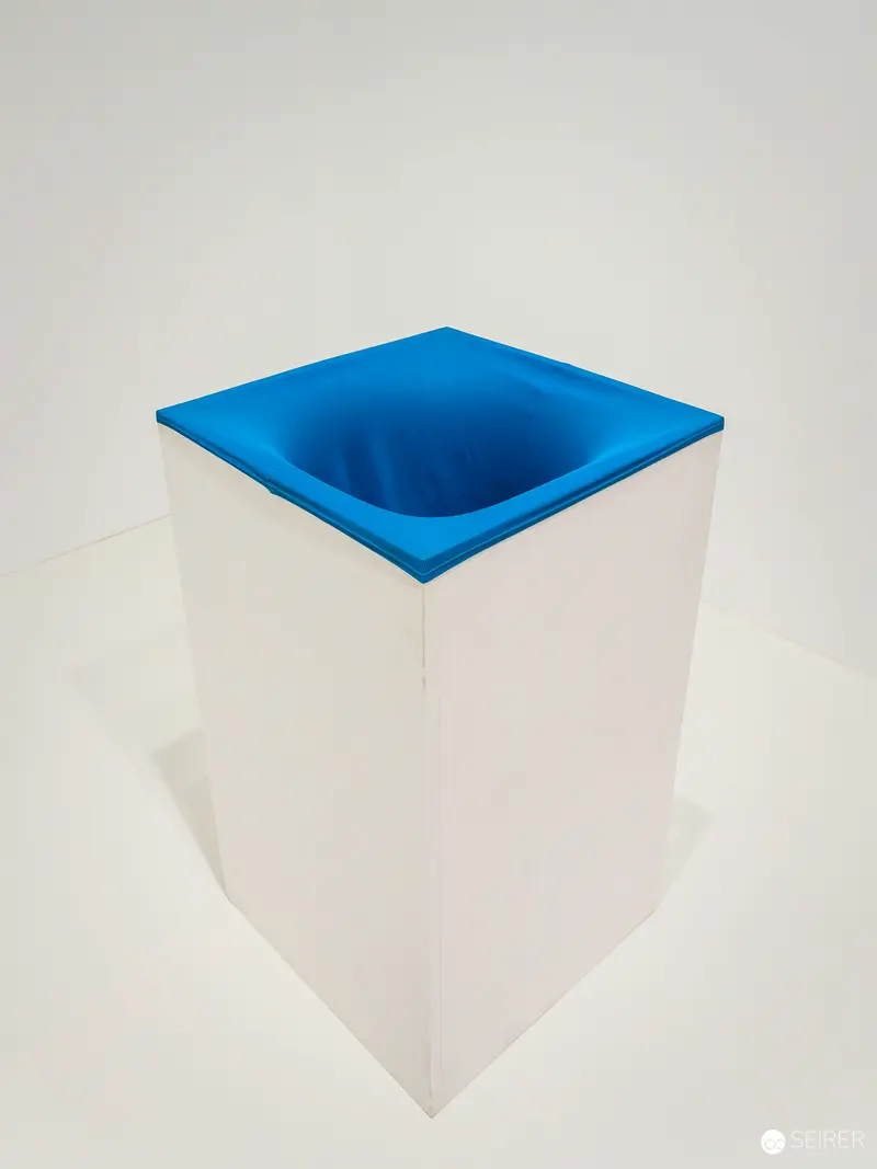 Blue Concave Surface on White Cubic Sculpture in Minimalist Setting