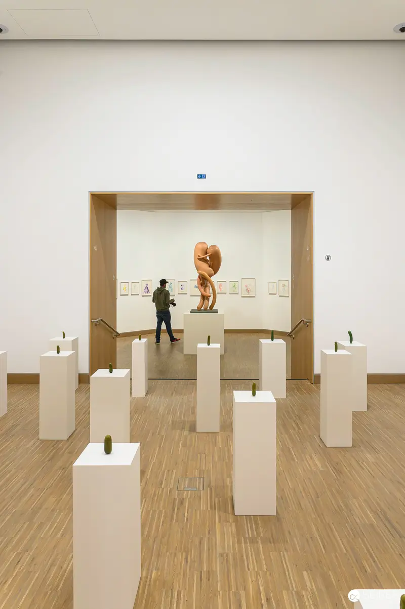 Erwin Wurm Exhibition at ALBERTINA MODERN: Sculptural Installation with Visitor