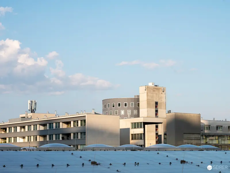 Modern Architectural Landscape with Geometric Buildings and Cellular Tower