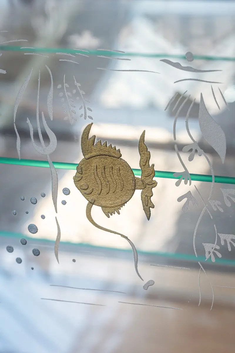 Decorative Gold Fish Silhouette on Etched Glass Surface