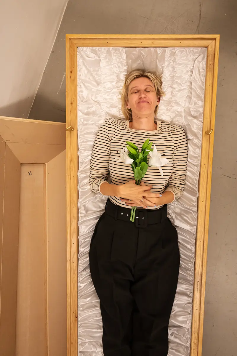Woman in Striped Shirt Holding Flowers Inside Wooden-Framed Doorway