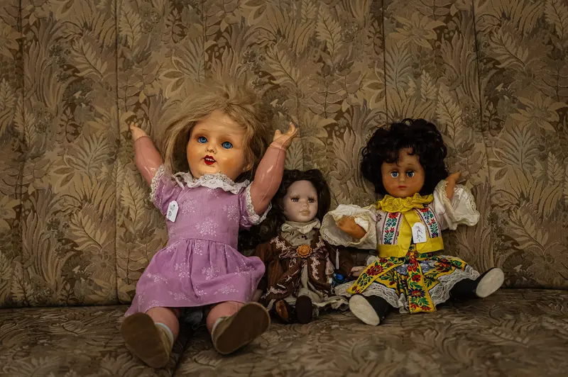 Vintage Dolls Posed on Floral Wallpaper Background