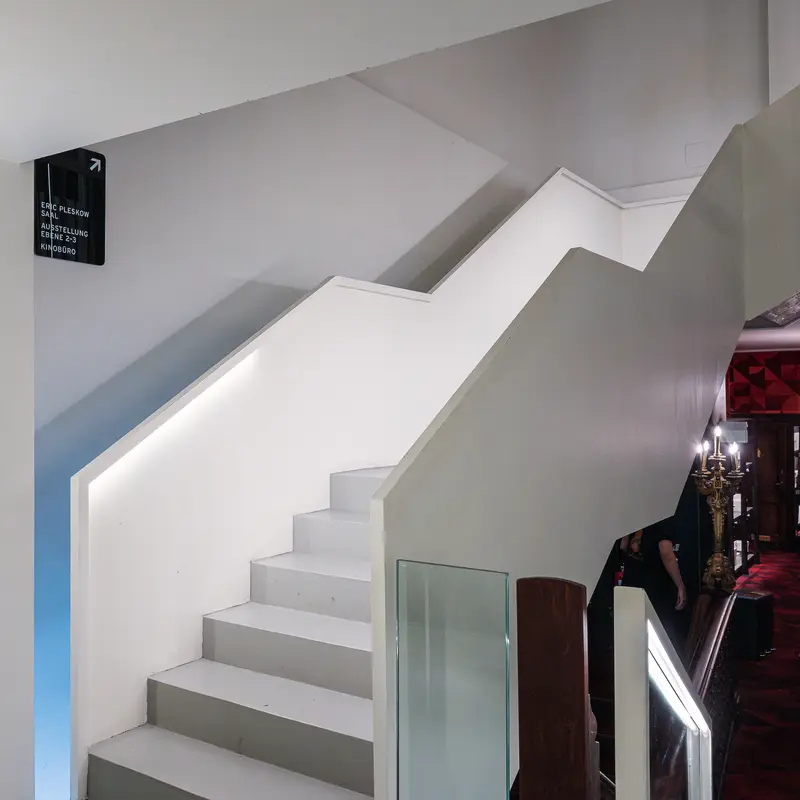 Modern White Staircase with Minimalist Glass Balustrade in Interior Space