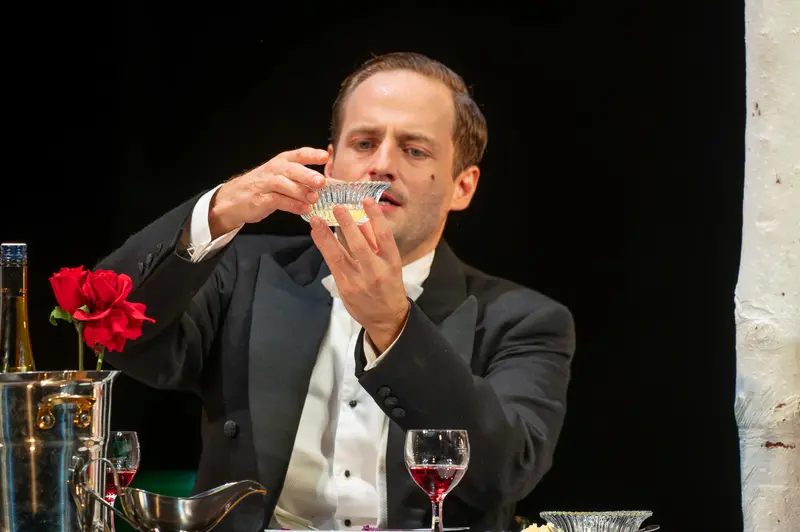Actor Drinking from Ornate Cup in Theater der Josefstadt Production