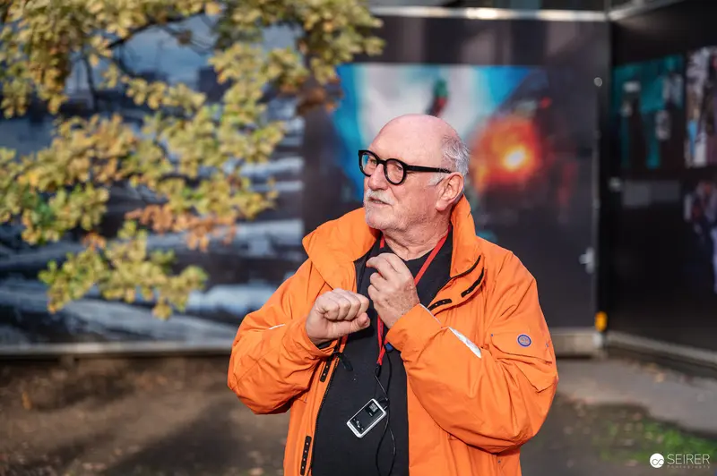 Lois Lammerhuber in Bright Orange Jacket at La Gacilly Baden Tour