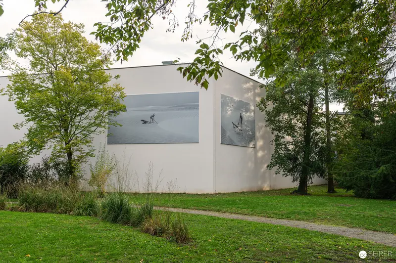 Modern White Cube Gallery Building Surrounded by Trees and Grass Landscape