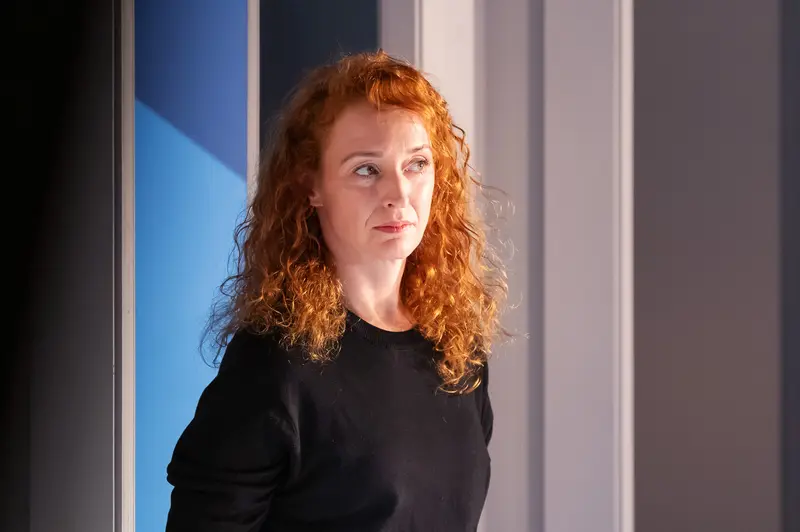 Curly-Haired Performer in Black at Theater Kammerspielen Performance