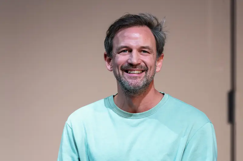 Joyful Actor in Turquoise Shirt at Theatrical Performance Rehearsal
