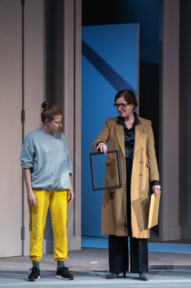 Theater Performance "Nachtlacht" at Kammerspielen - Actors in Blue and Yellow