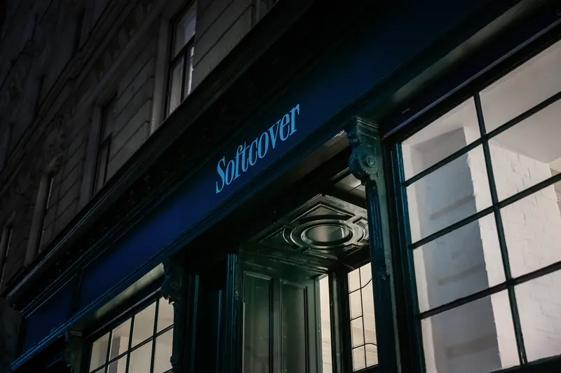 Softcover Storefront at Night with Blue Illuminated Signage