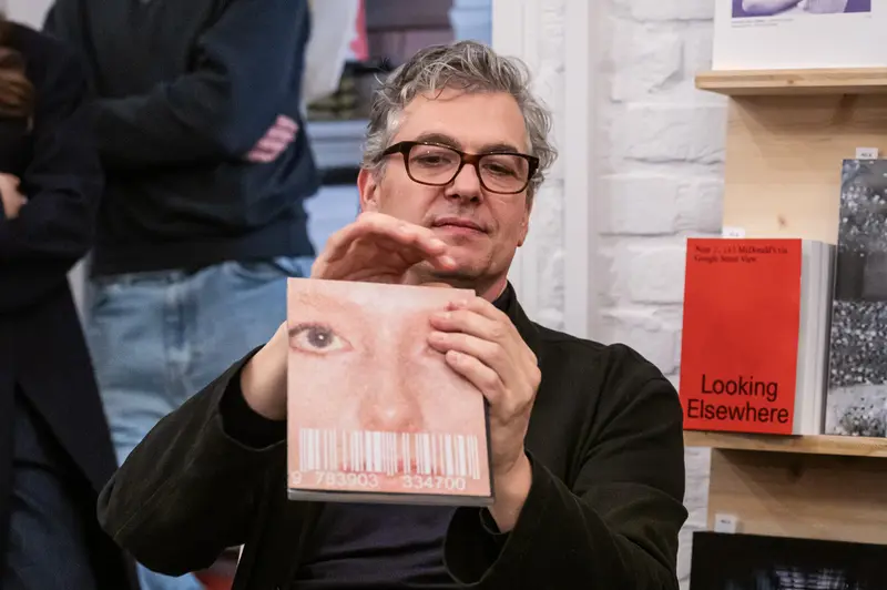Felix Hoffmann Presents Book at Arsenal Wien with Distinctive Eye-Themed Cover