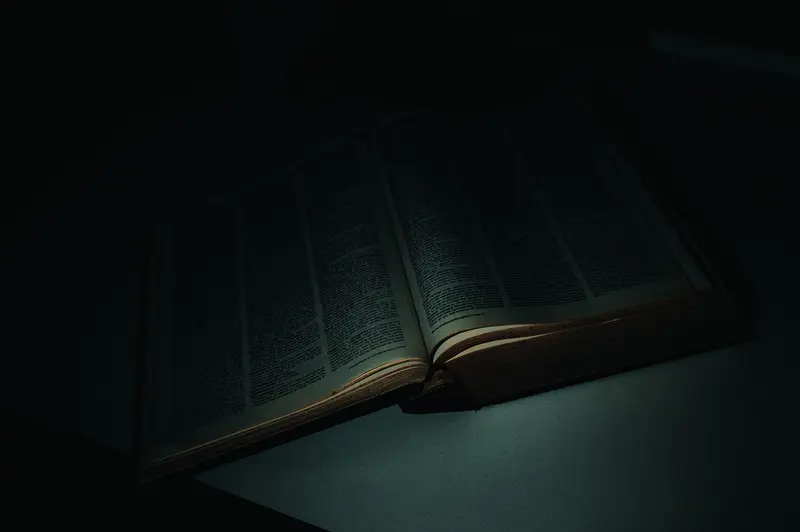 Haunting Open Book in Moody Dark Scholarly Setting
