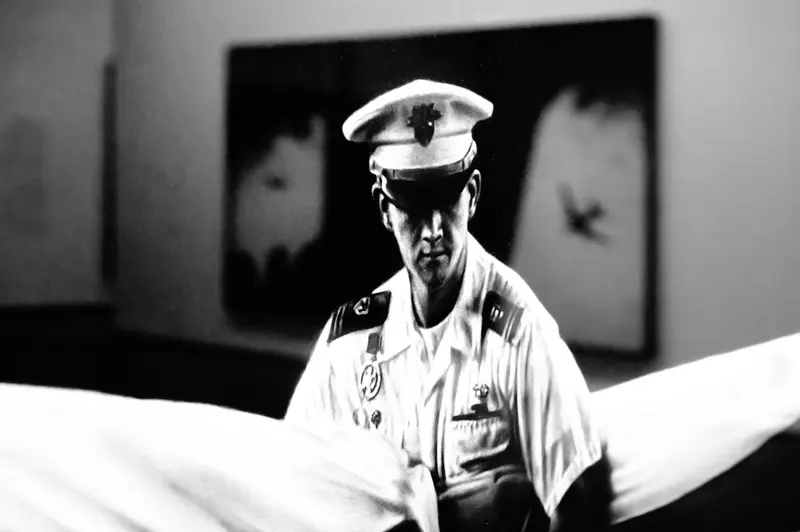 Military Officer in Crisp White Uniform at Formal Exhibition Setting