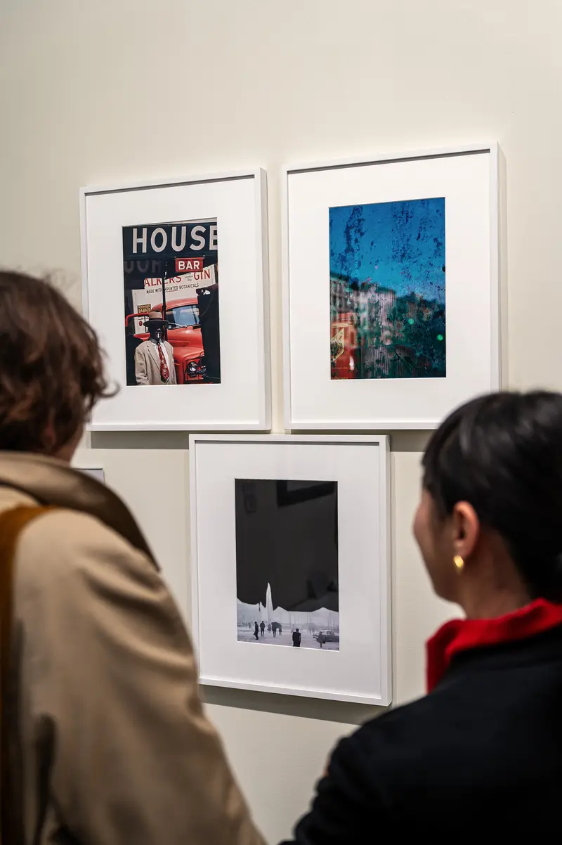 Visitors Examining Framed Photographs at Paris Photo 2024 Art Exhibition